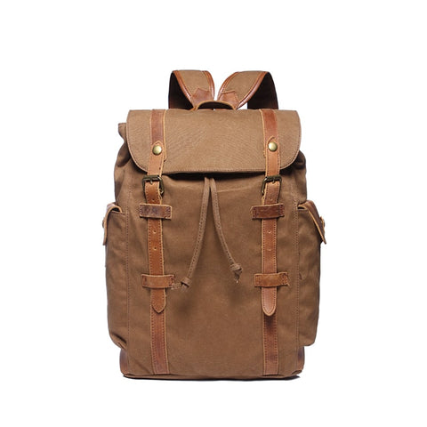 Brown water-resistant canvas and leather backpack with pockets and a laptop compartment