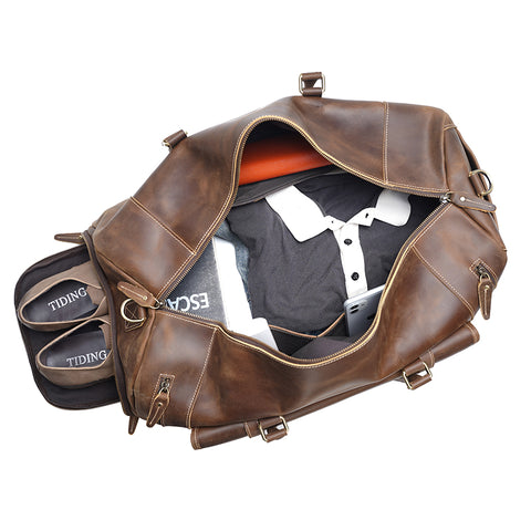Brown large duffel leather bag with zippered pockets, adjustable shoulder strap and shoe compartment