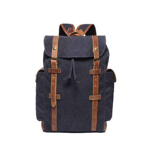 Navy blue water-resistant canvas and leather backpack with pockets and a laptop compartment