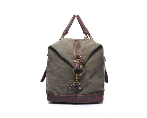 Green canvas and leather weekend bag with adjustable shoulder strap, sturdy top handles and inner lining