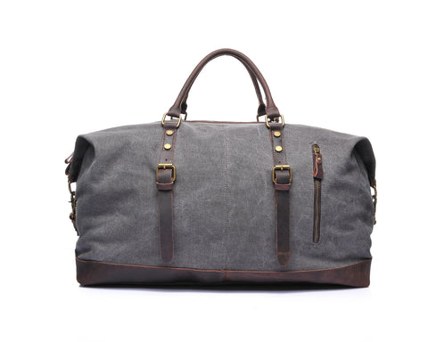 Gray canvas and leather weekend bag with adjustable shoulder strap, sturdy top handles and inner lining