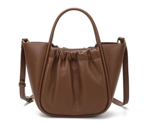 Handmade waterproof brown 100% top-grain genuine leather bag for women with inner pockets and inner lining.