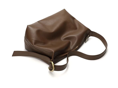 Soft brown waterproof top-grain leather bag with sturdy top, inner pockets and inner lining.
