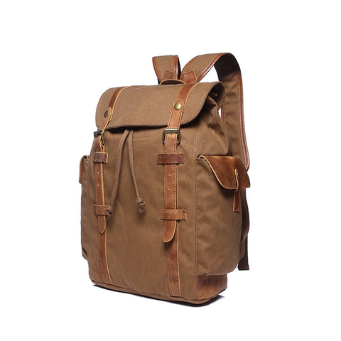 Brown water-resistant canvas and leather backpack with pockets and a laptop compartment