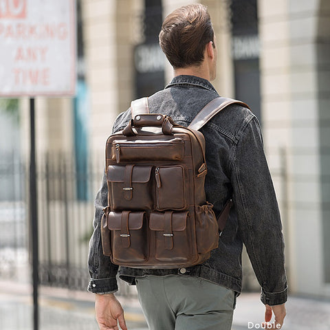 Handmade dark brown full grain cow genuine leather travel backpack bag with laptop compartment, many front pockets and adjustable shoulder strap.