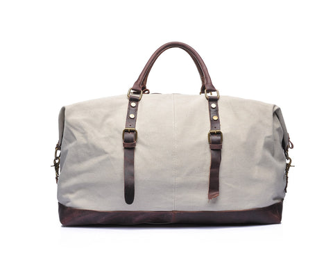 Beige canvas and leather weekend bag with adjustable shoulder strap, sturdy top handles and inner lining