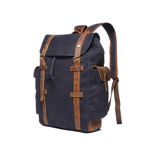 Navy blue water-resistant canvas and leather backpack with pockets and a laptop compartment